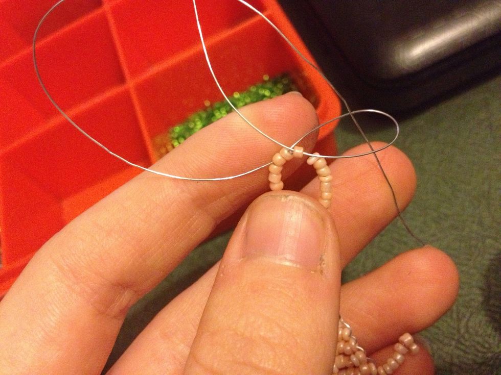 Drop the wire from the other side through it to create a knot