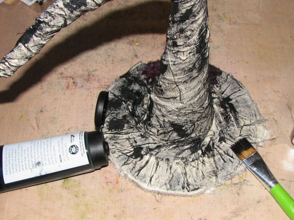Dry brush a layer of black paint over the hat.
