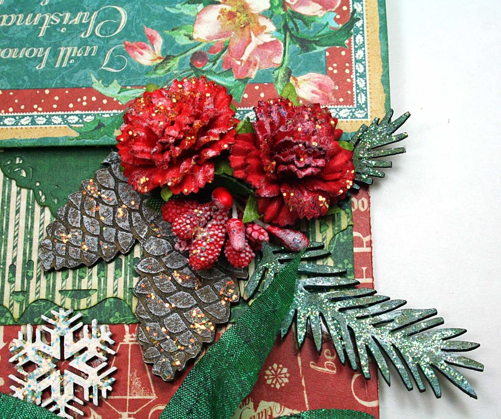 Dry brush some white paint on the flowers, pine cones and needles to simulate snow.  Then use Icicle Stickles to detail the pine cones and flowers.  Use Crystal Stickles to detail the pine branches.