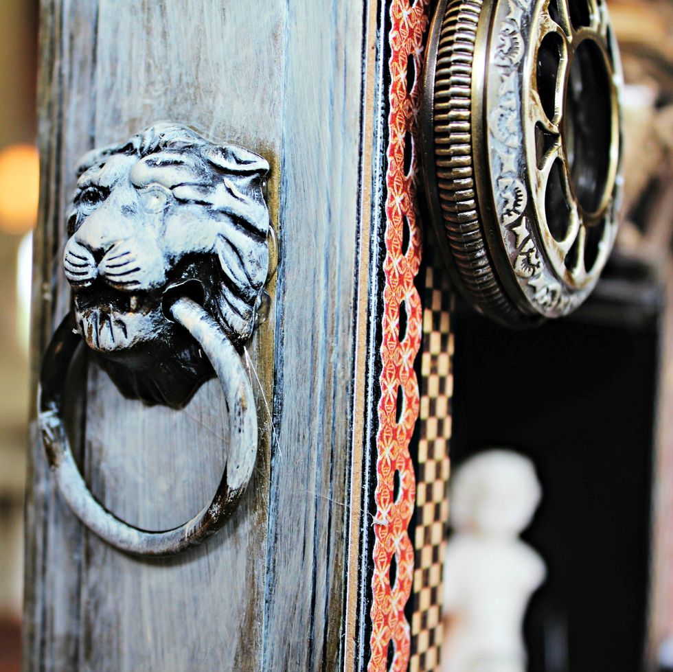 Dry brush Titan Buff paint over metal knob and door plate.