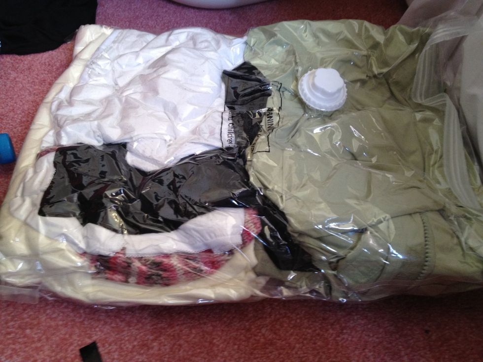 Dry clothes in a waterproof  bag, also a vac bag to save space. I have thermals, track suit, undies, hat , scarf, gloves and a coat! (it's cold in the uk!)