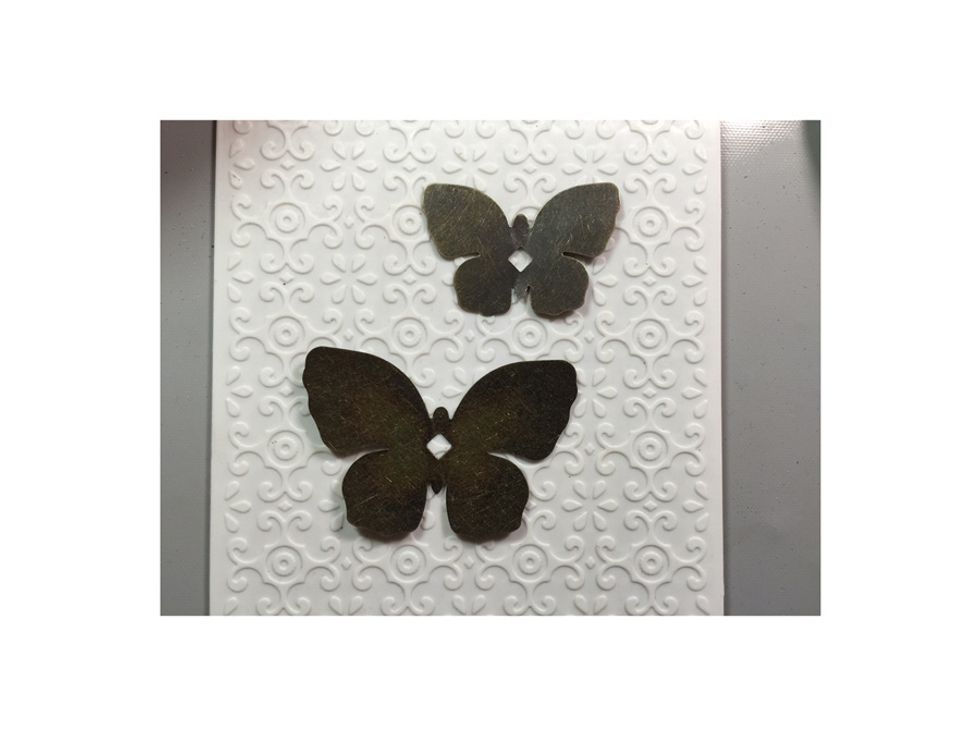 Dry emboss in a deep embossing folder a pair of Graphic 45 metal butterflies.