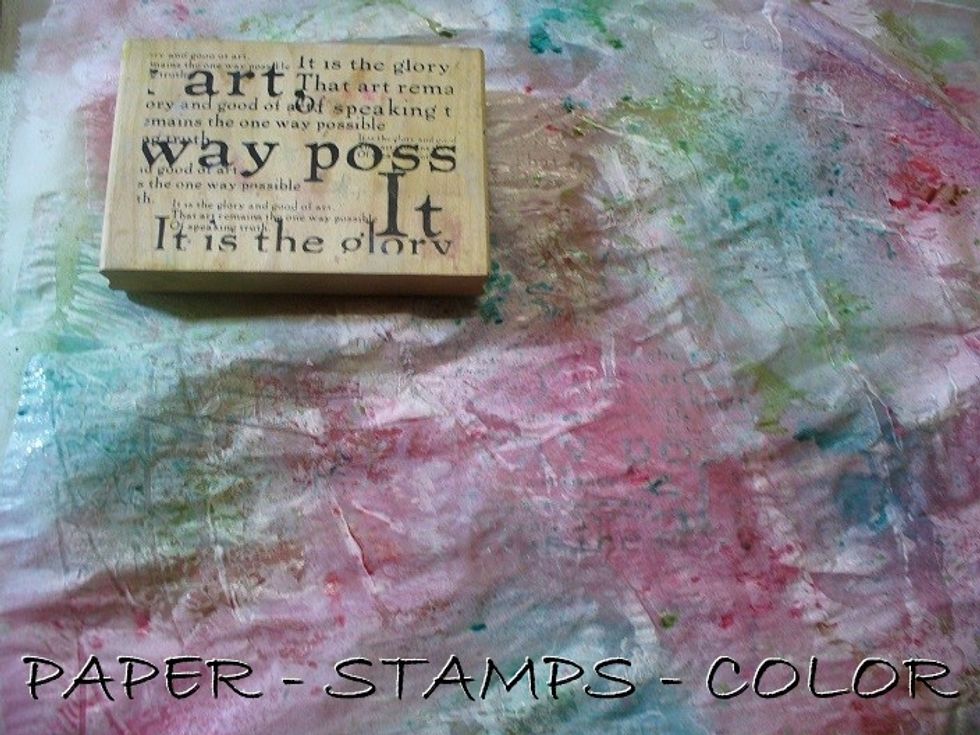 Dry it partially. Stamp onto the surface with a script stamp, lifting some of the color and gesso. Restamp on another part of the background. Continue until you are happy with the result.
