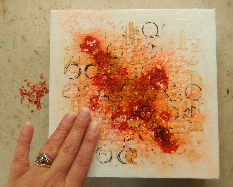 Dry the surface with a heat tool. At this point some of the Crazing Medium may begin to fall away from the canvas. Rub the surface to encourage this process to create a more patchy look.