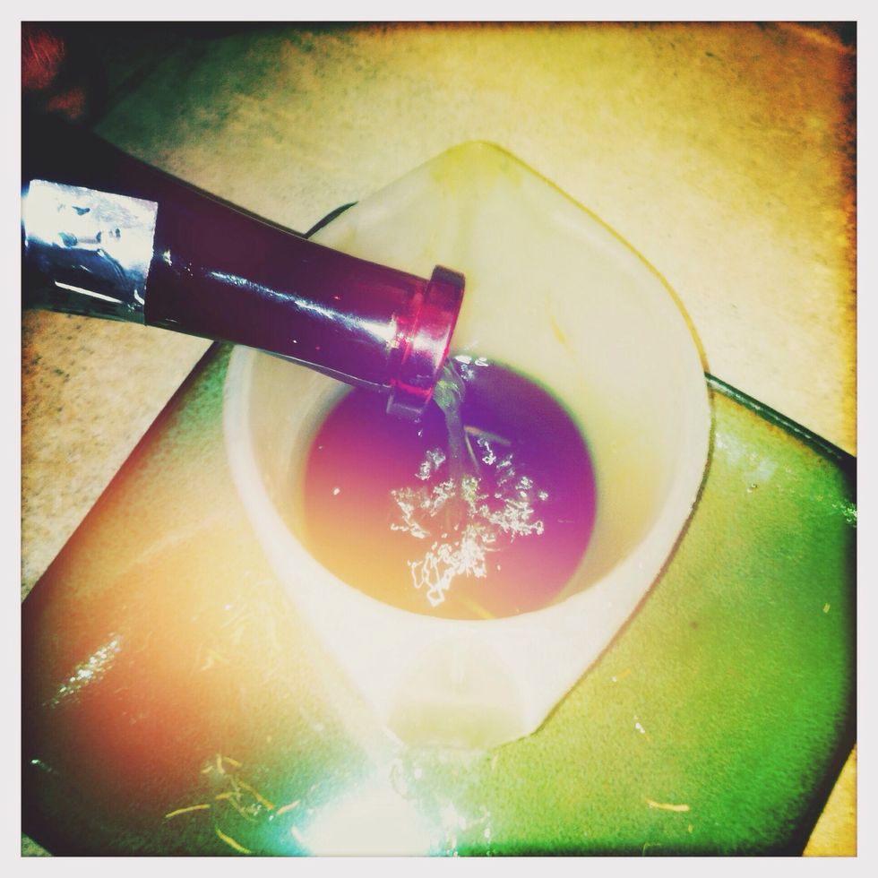 Dump all contents of the bottle into the measuring cup