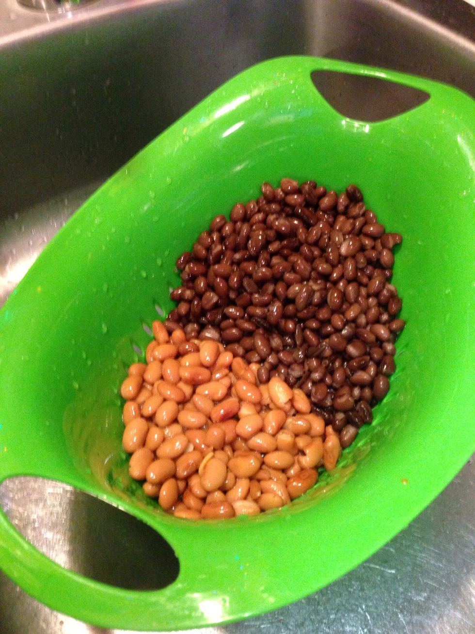 Dump both cans of black beans but only one can of ranch style beans into a strainer. Leave the other can of Ranch Style beans on the counter with its juice intact.