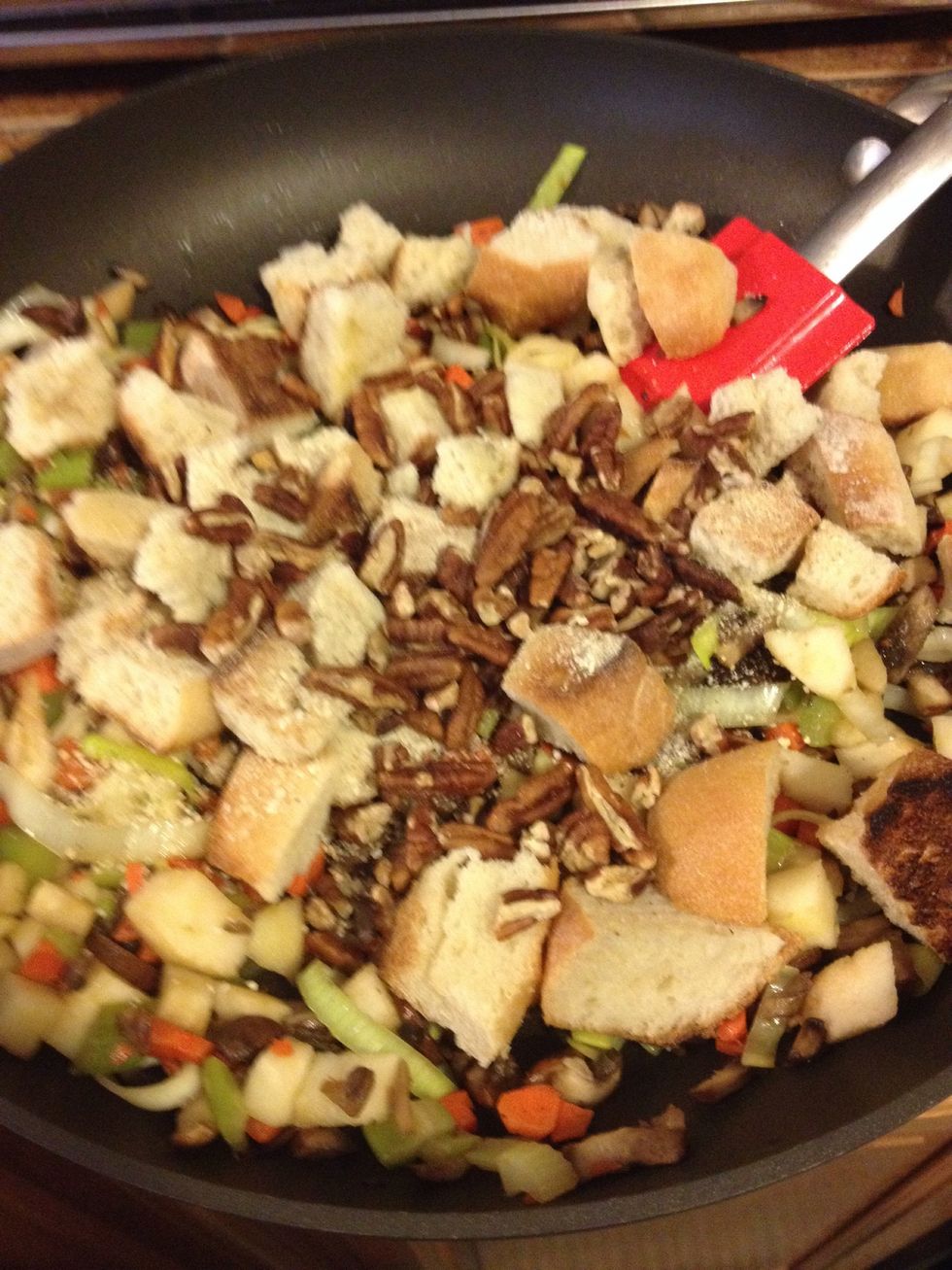 Dump bread and nuts into saut\u00e9 pan and mix.