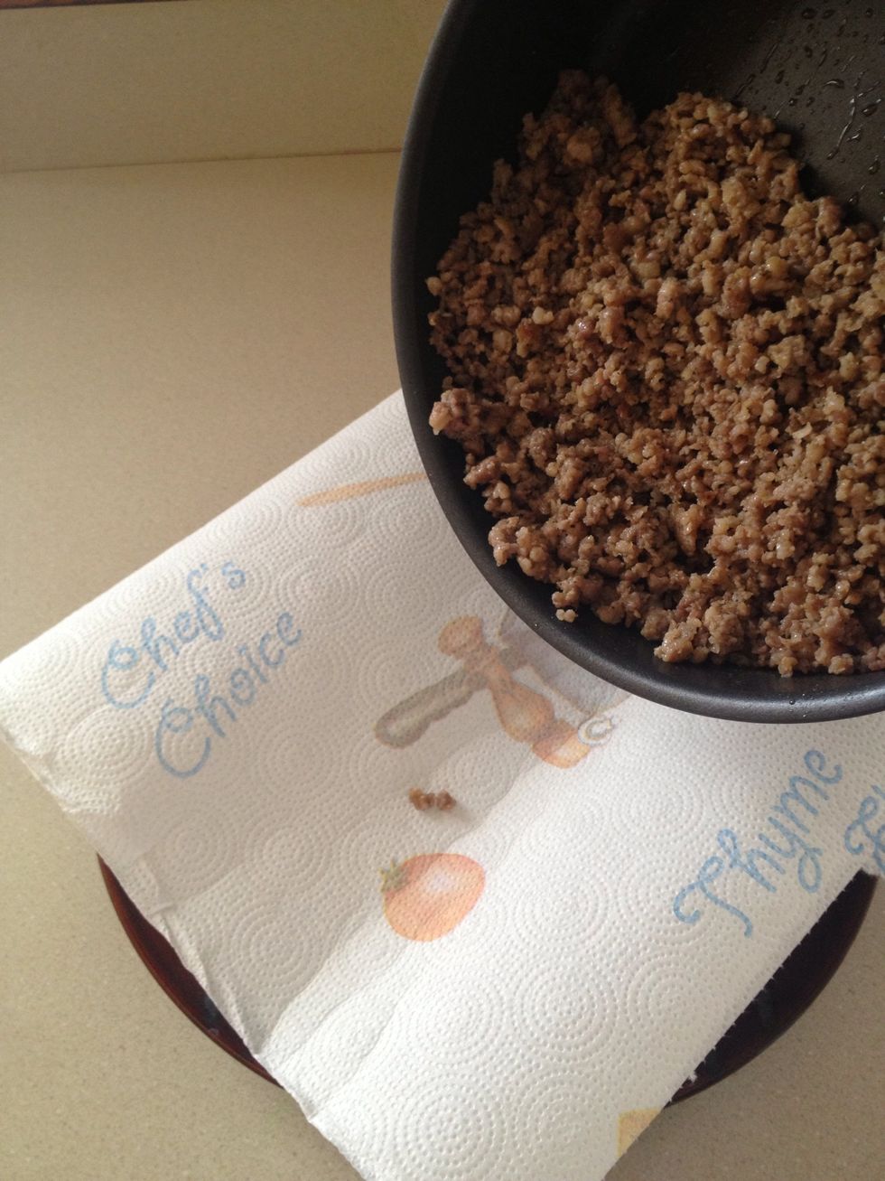 Dump cooked sausage on top. This will soak up the grease.