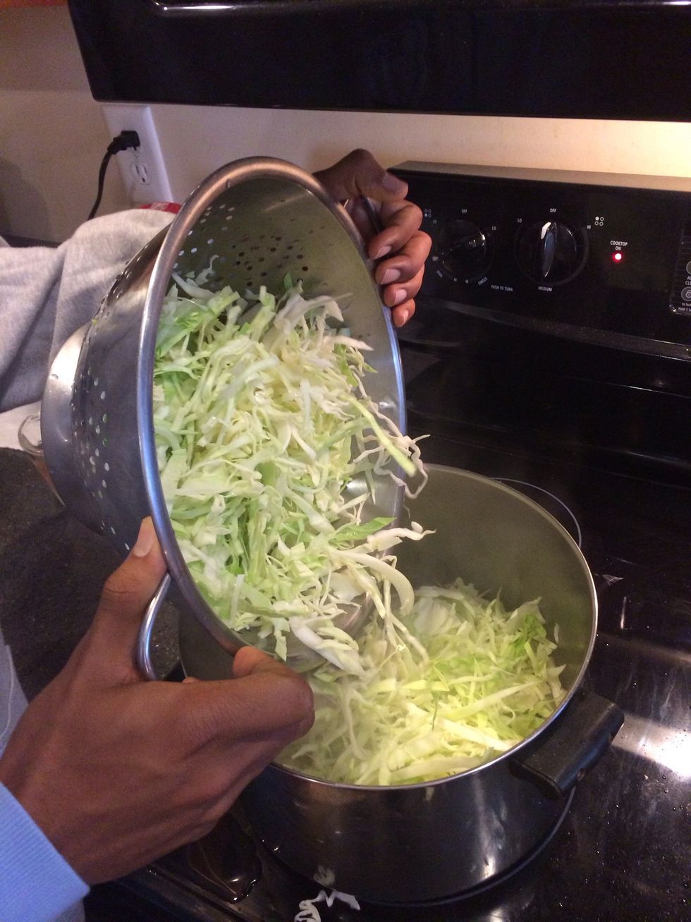 Dump in cabbage, put on lid, medium heat, light boil under cabbage to create steam.