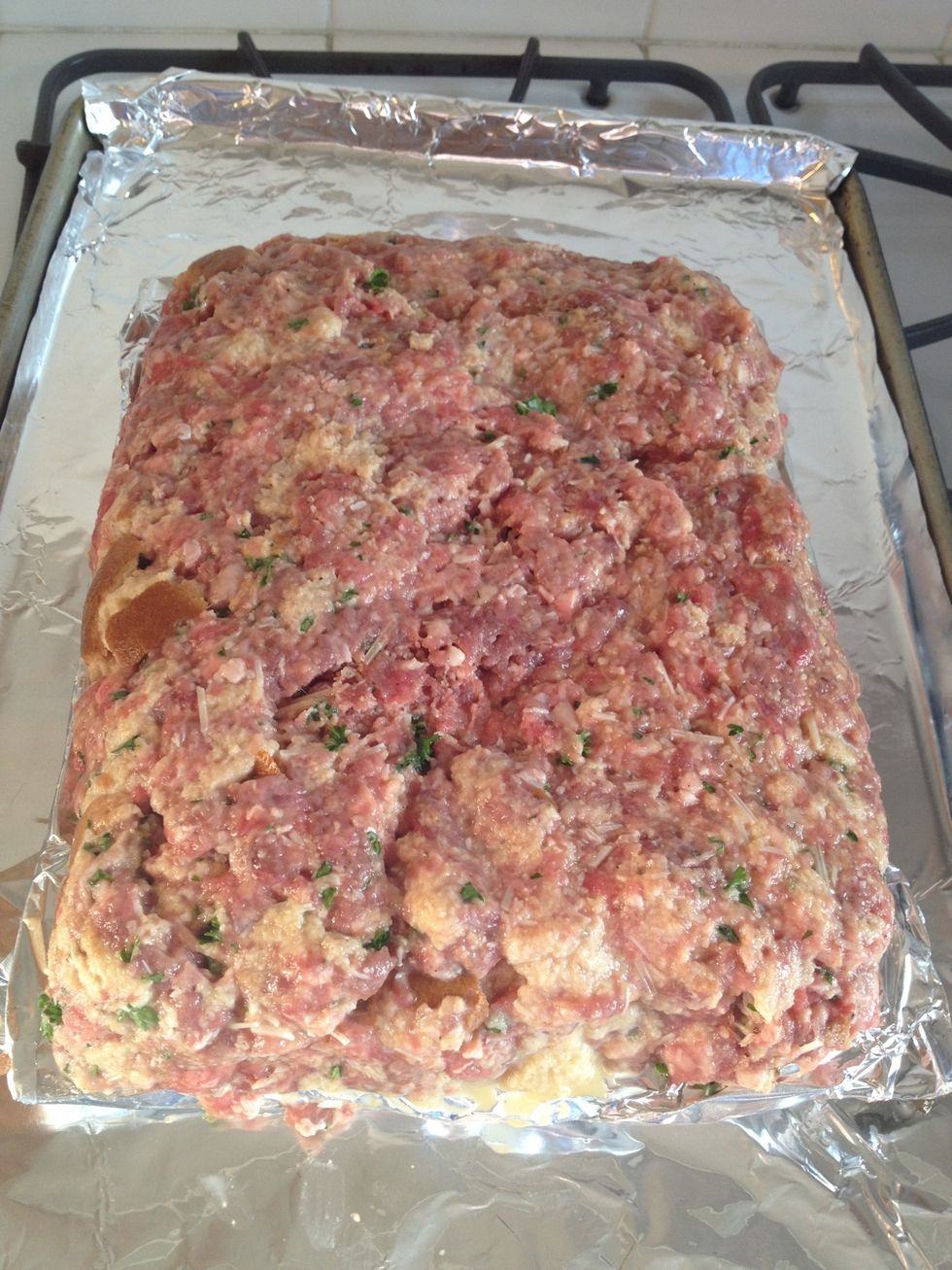 Dump in on a foiled lined baking sheet or a broiler pan of you want to allow some of the fat to drain. With your hands, for it into a loaf shape