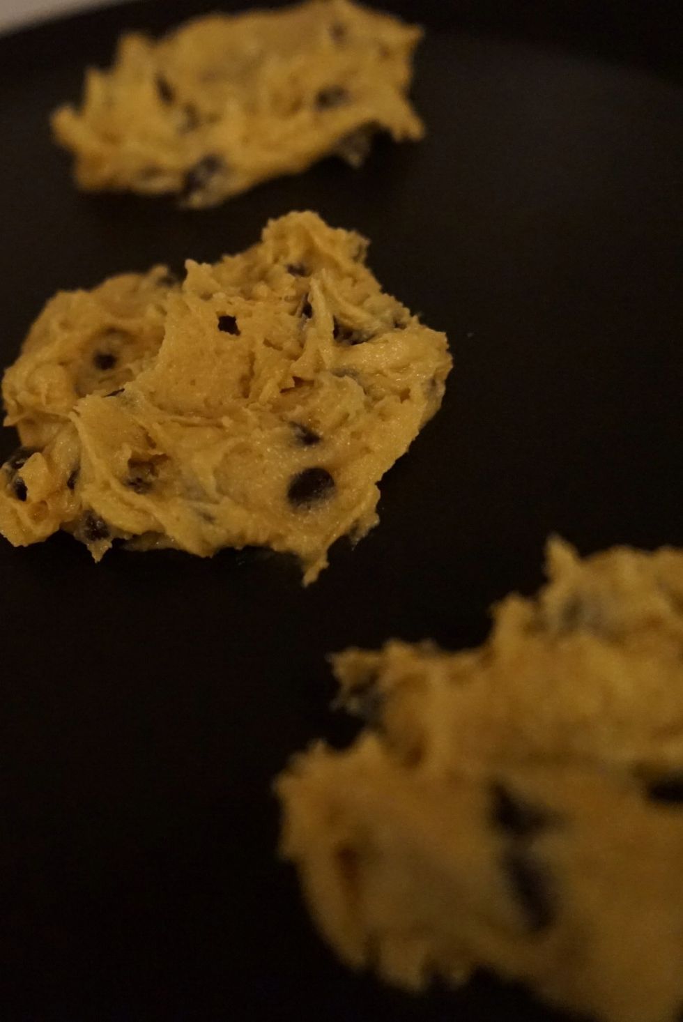 Dump in the choco chips, mix well and place on buttered (if not use non stick line the tray) tray.