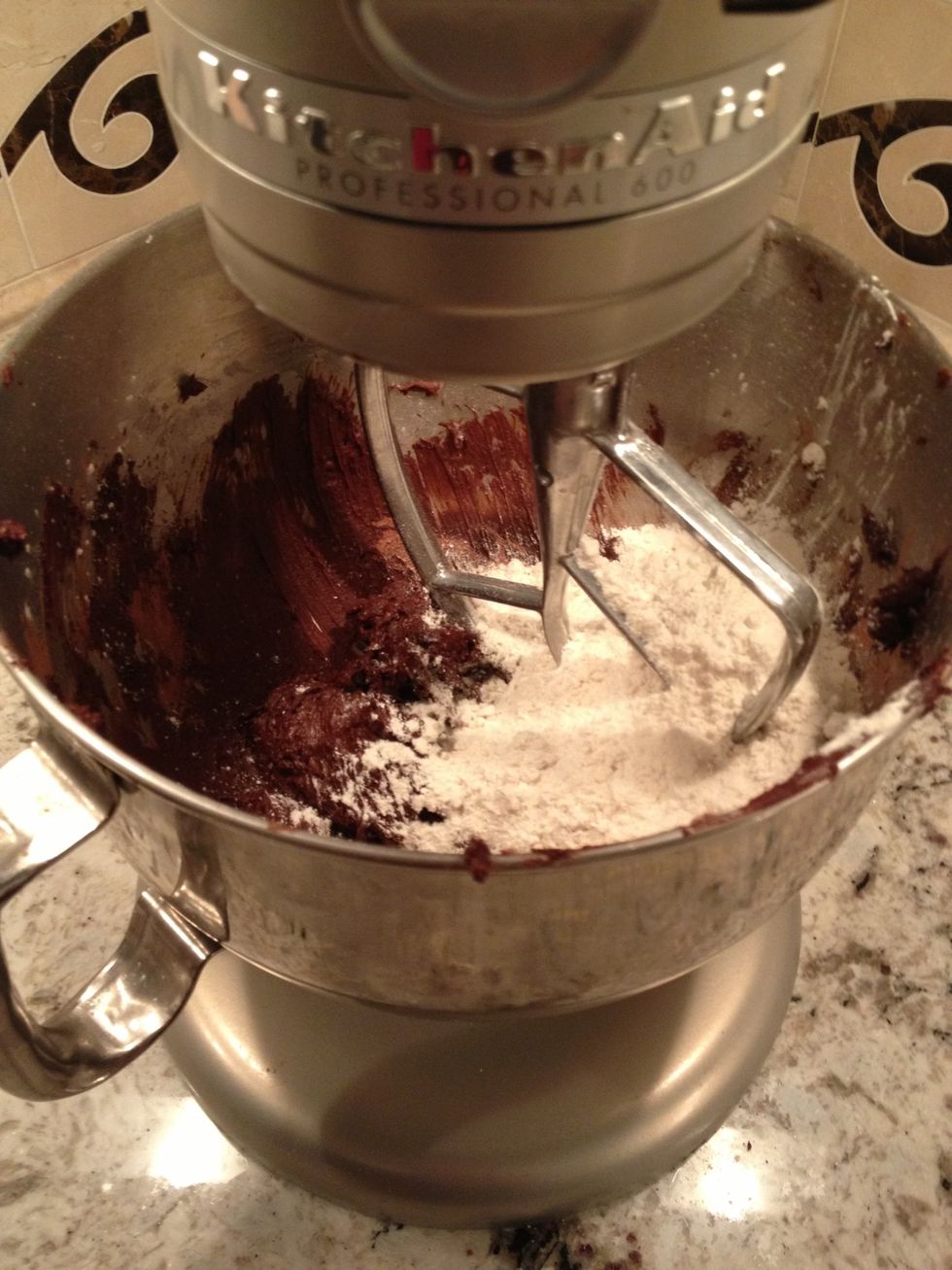 Dump in the flour all at once and scrape down the sides.