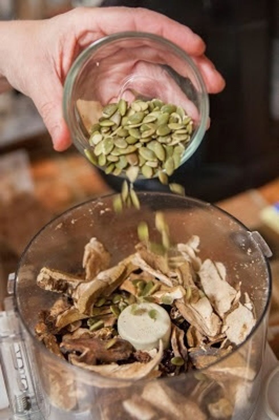 Dump the chopped nuts in a food processor along with the pumpkin seeds, Wasa crackers, dried Porcini mushrooms and dried onion. Break the crisp Pumpernickel bread into chunks and toss it in also.