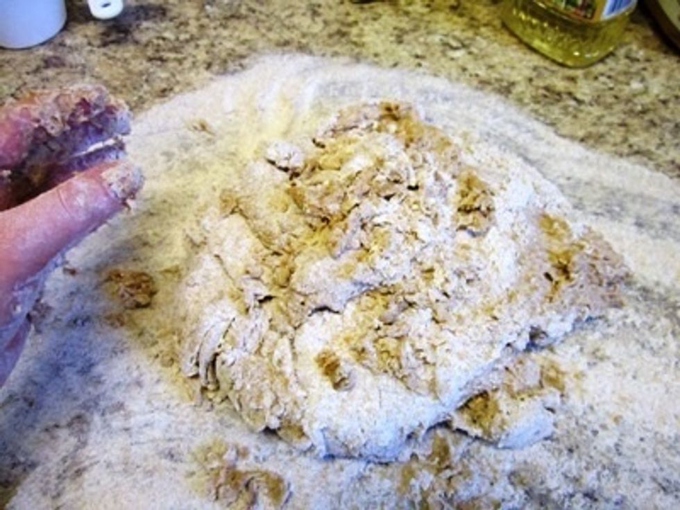 Dump the dough out of the bowl (pot) and onto the floury surface. The next 3 pictures show the sequence of motions used for kneading.