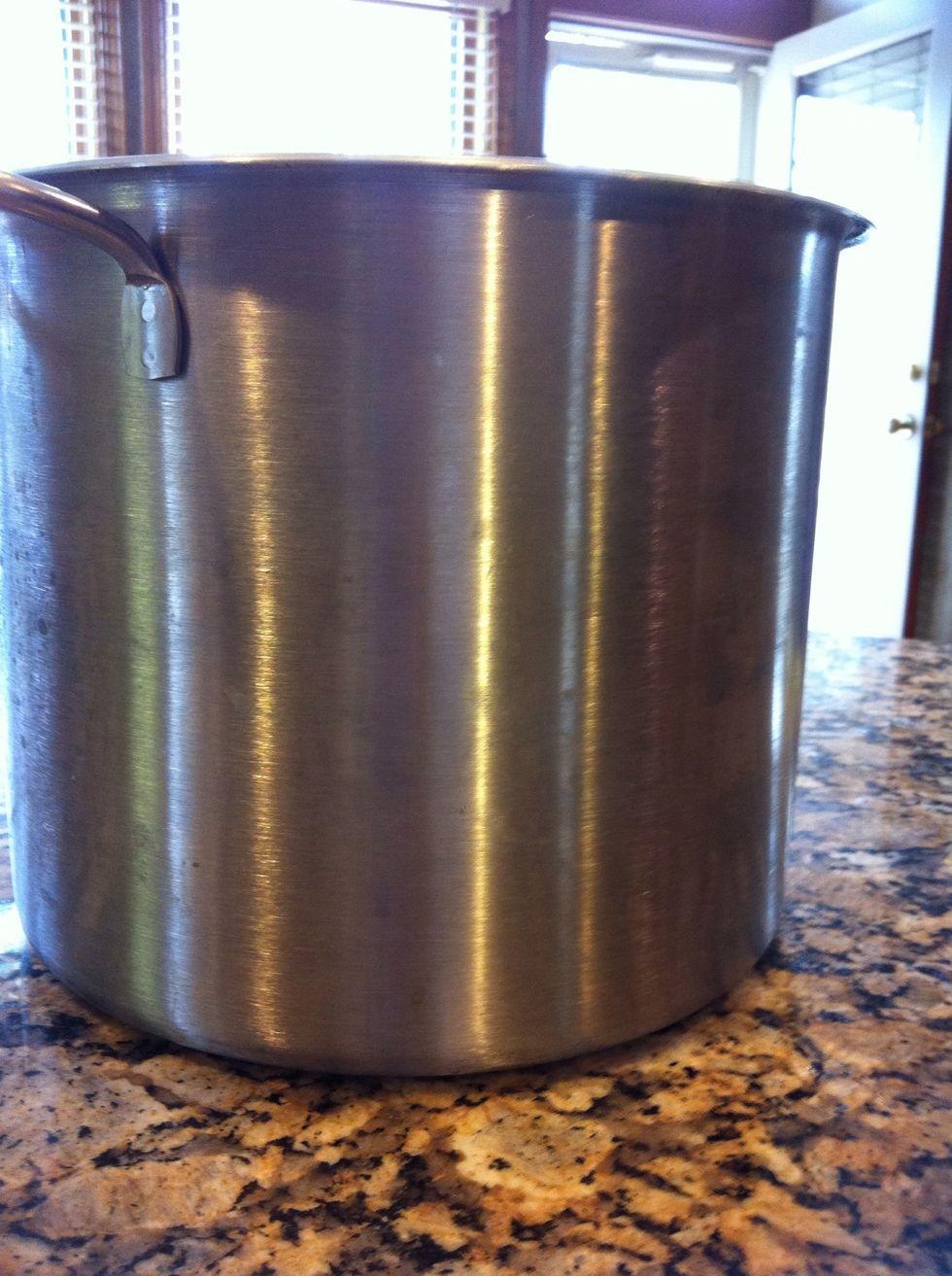 Dump three bags of the popped corn into a large container. I use this stock pot. You need to divide it up so that it's easier to coat once you make the caramel