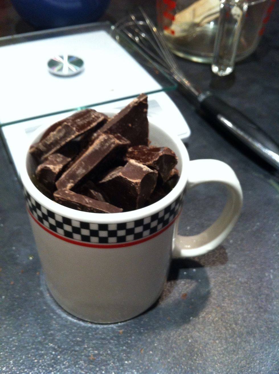 Dunk the cooking chocolate into the mug containing melted butter