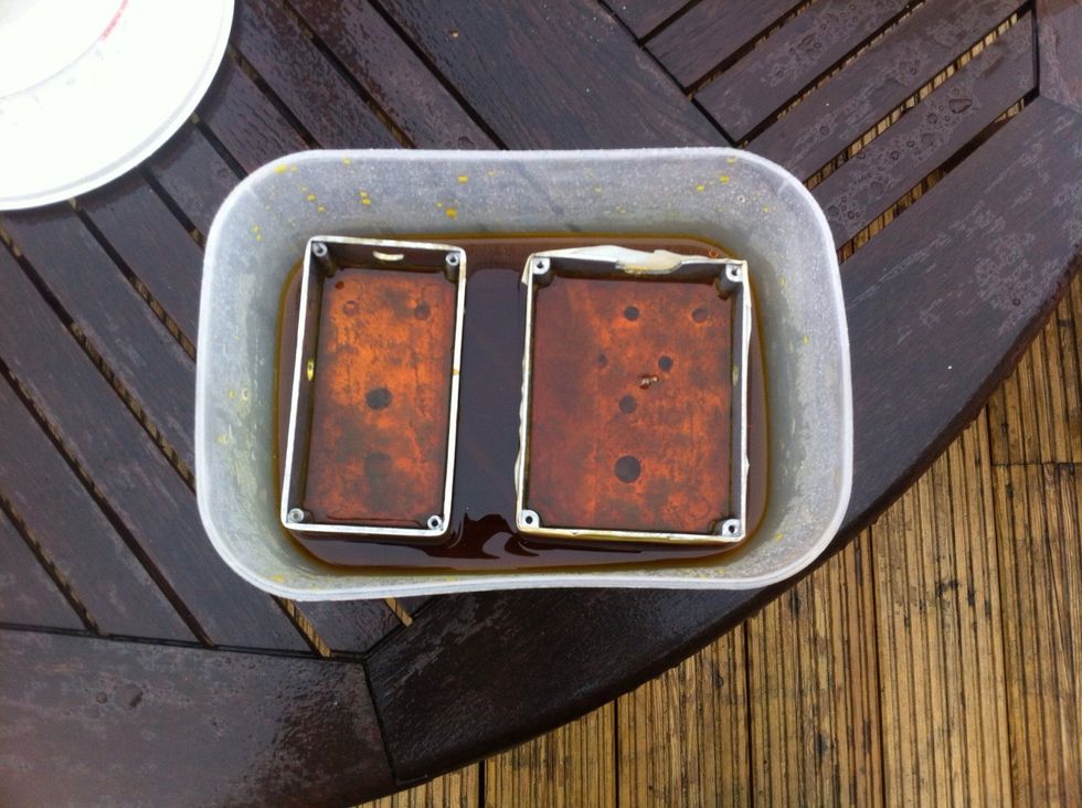 Dunk your boxes into the ferric chloride solution. (follow the instructions on the packet. Don't take shortcuts, or you'll hurt yourself). Keep agitating the tub, and rinse the boxes periodically.