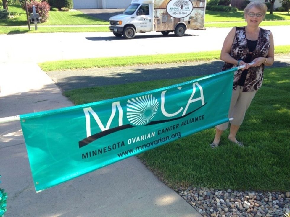 During the parade, two people can hold the banner sign in front of the float.