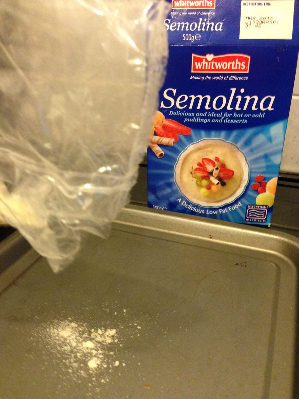 Dust 2 baking trays with semolina. This will help the bread not to stick.