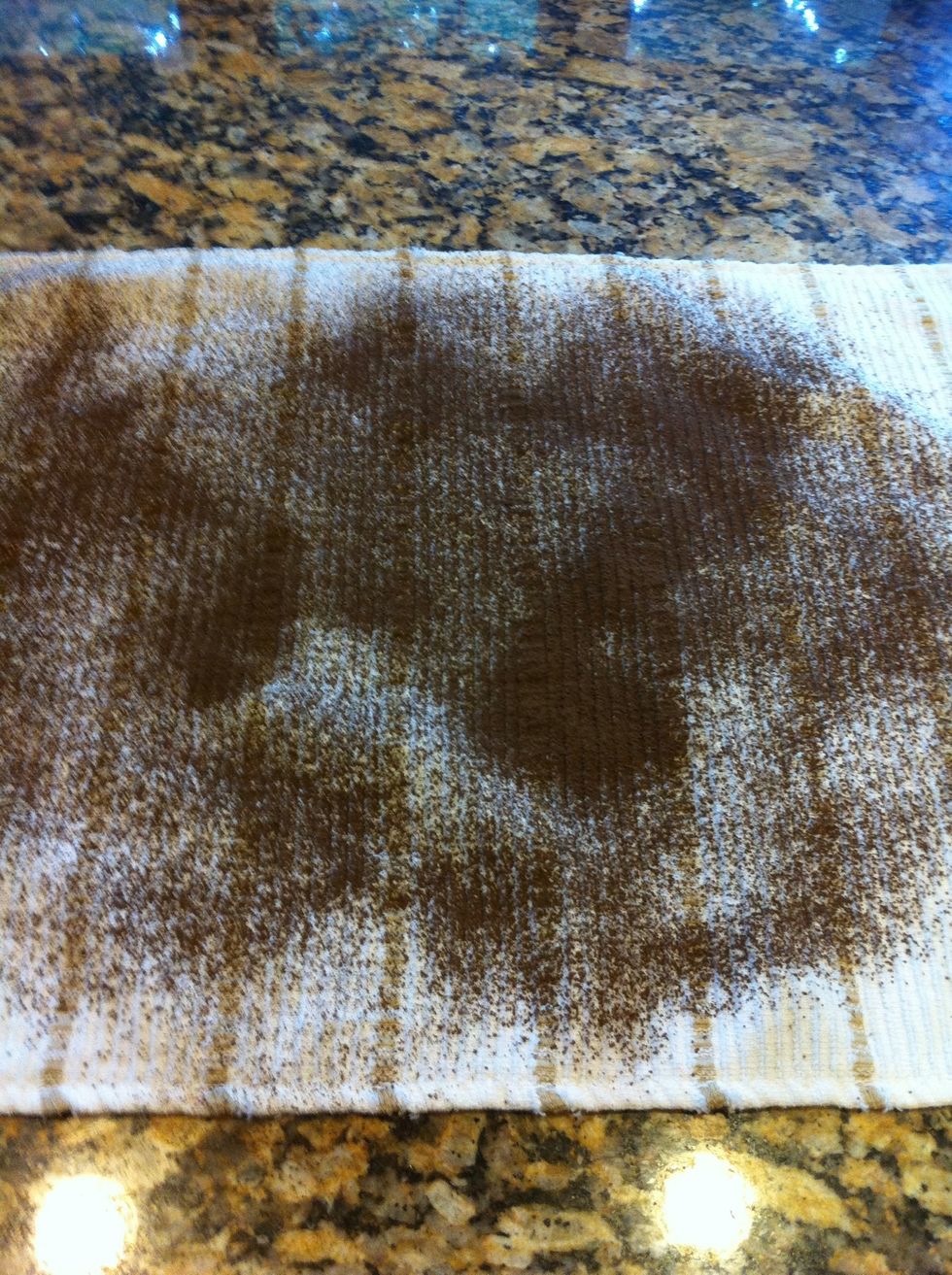 Dust lightly with the cocoa powder, a kitchen towel