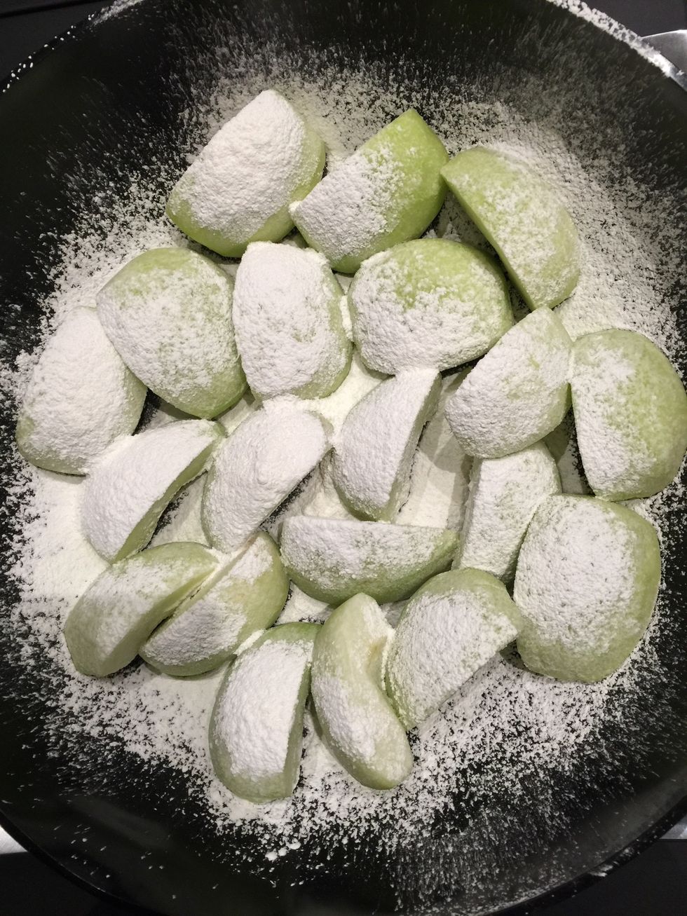 Dust the generously with corn starch. And let stand for few hours or the night before. This will serve 2 purposes. Absorb the extra liquid & later will help to thicken the sauce while tart is cooking.