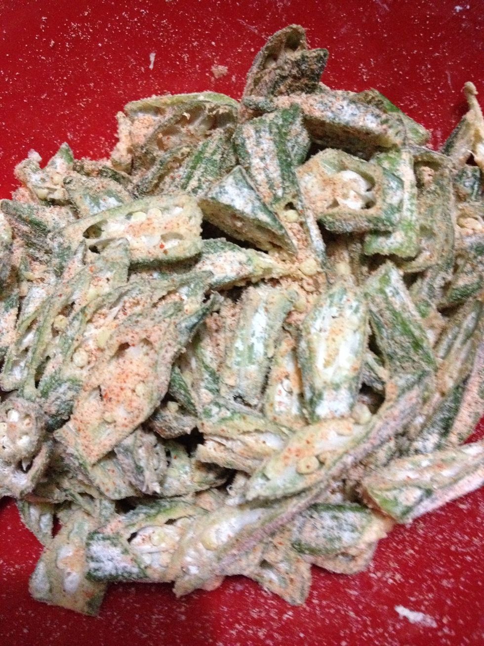 Dust the okra with corn flour, chilli powder, cummin powder and salt . Dont add water to this . Leave it for sometime corn flour will absorb some moisture.