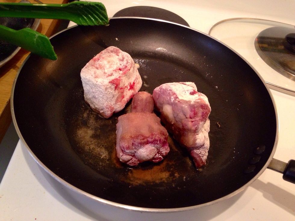 Dust the oxtail in flour and fry in a pan on the stove to brown the meat - do it in small batches so there is space between the pieces ... You don't want the meat to boil.