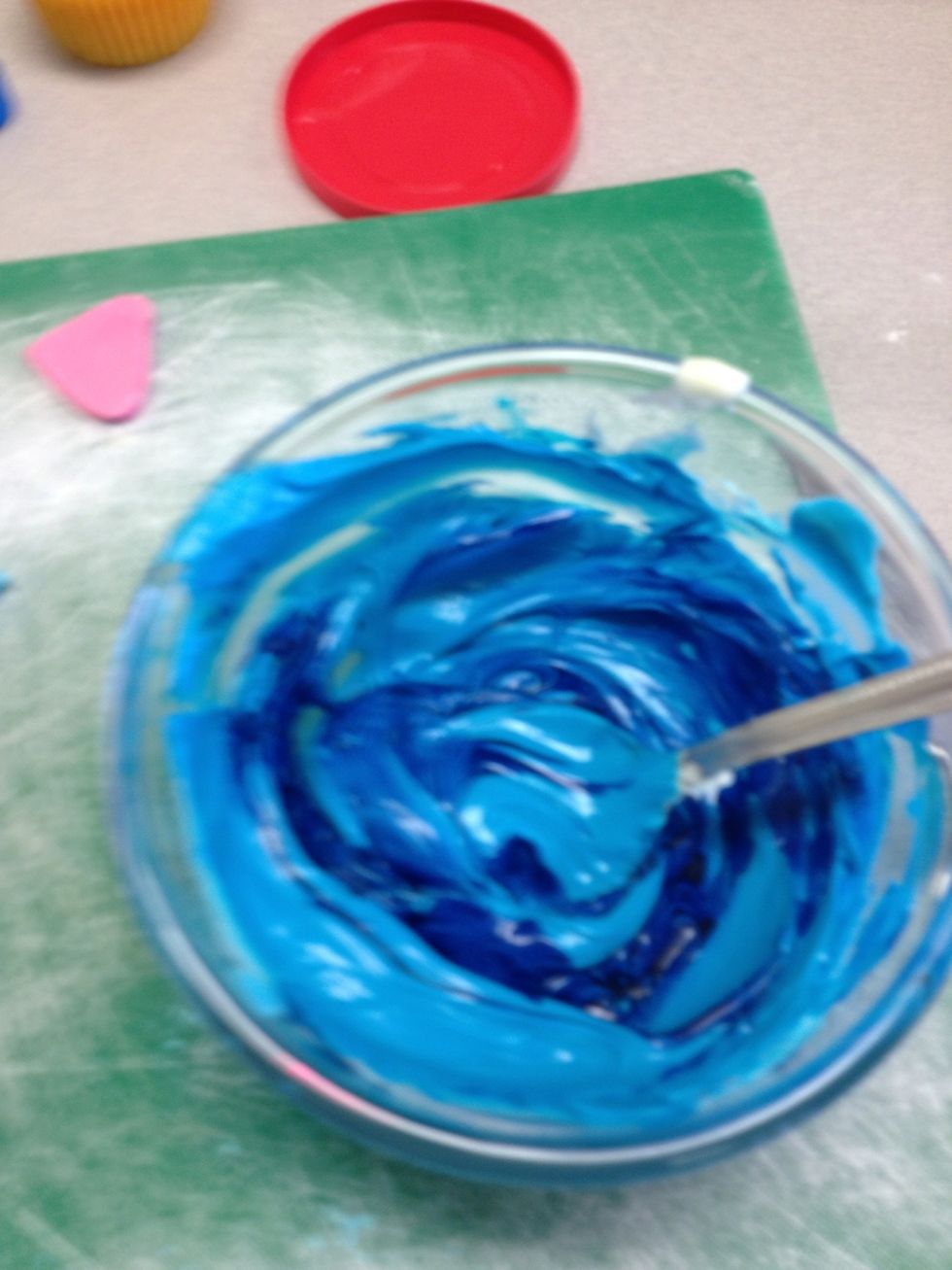 Dye icing blue and spread on the cupcakes!