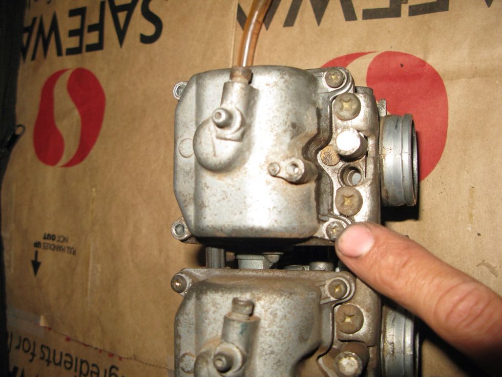 Each carb has 4 screws. They are the small ones and are on tight. Avoid stripping them by breaking them free first with vice grips.