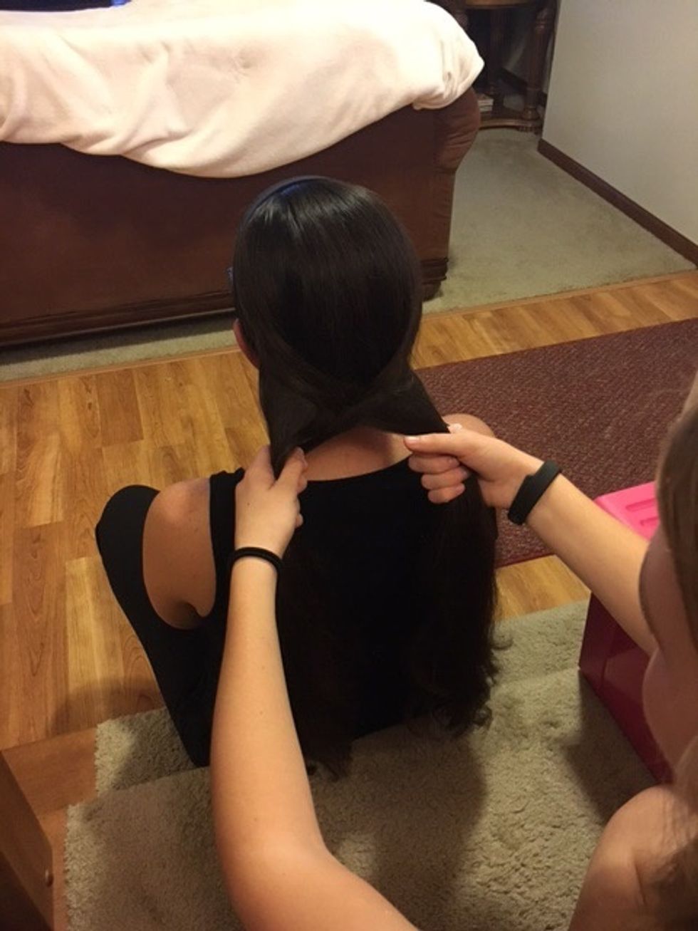 Each time you bring hair over, pull it tight to keep it together.