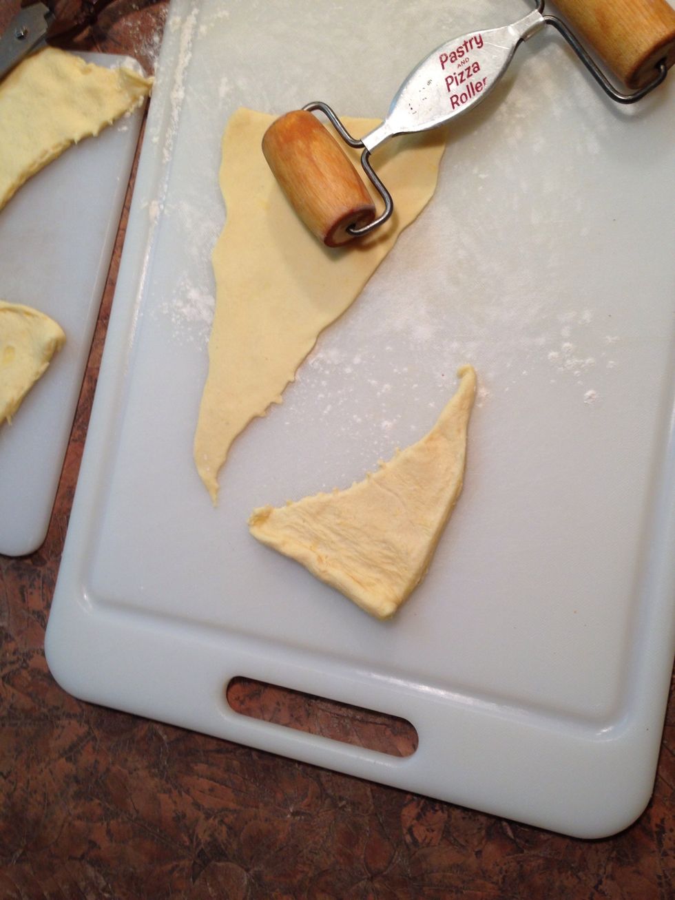 Each triangle needs to be rolled larger in order to make it wrap completely around meat/egg. Lightly dust surface and roller with flour to prevent sticking.