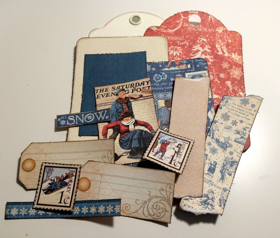 Edge distress all of the edges of the patterned papers and cut aparts. Once the edges have been distressed, ink the edges using Walnut Stain Distress Ink and a blending tool.