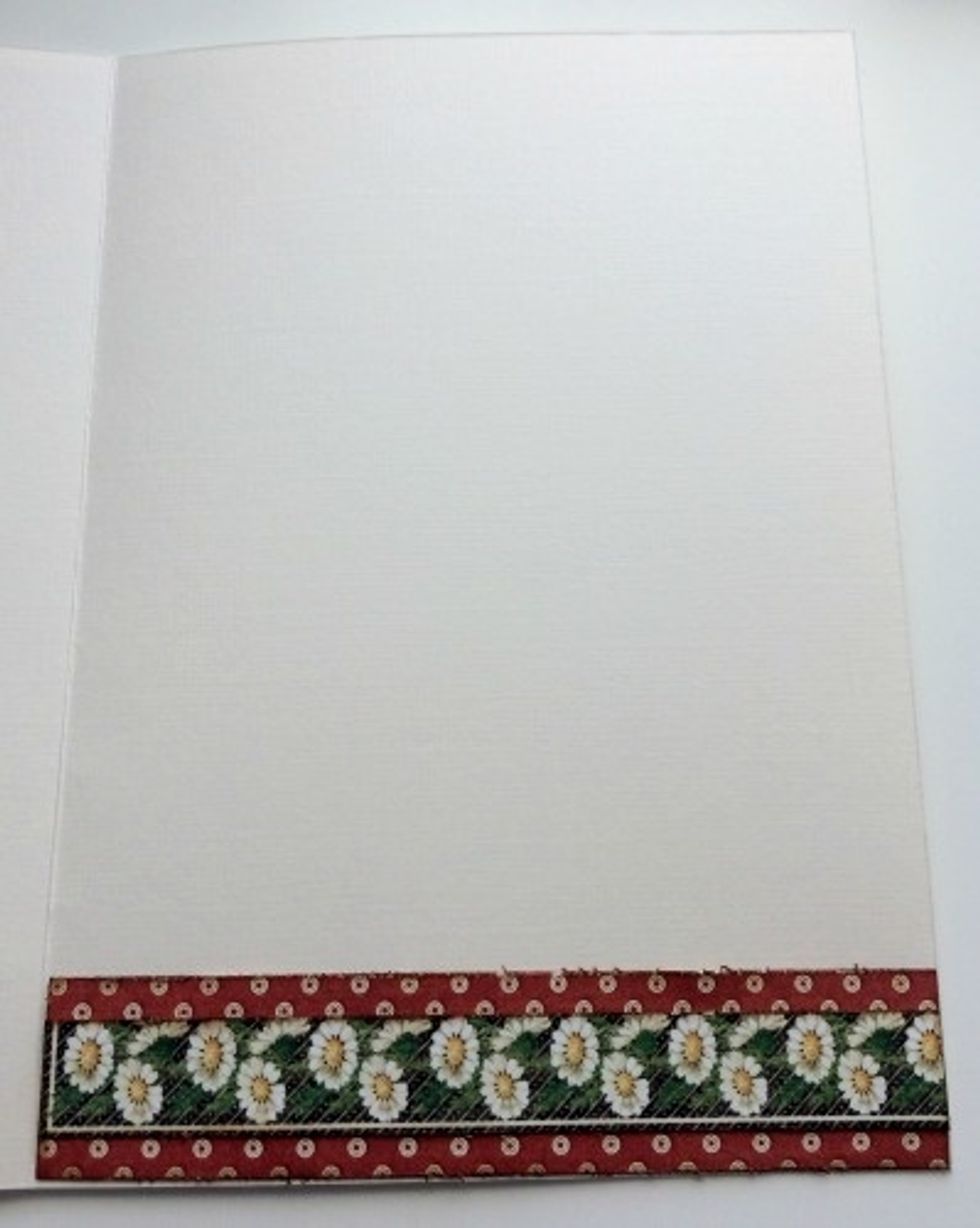 Edge distress and ink the edges of the patterned papers. Adhere the red and white dot paper to the bottom inside of the card. Adhere the daisy border to the middle of the red and white dot paper.