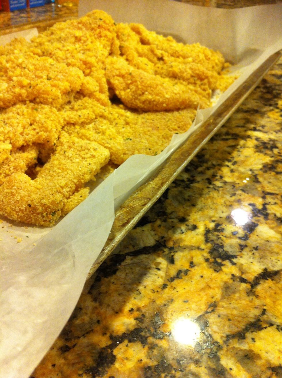 Egg mixture, breadcrumbs, then place on a tray until its all coated. Remember: use opposite hands (one for egg, the other for breadcrumbs) or else you'll have more crumb on your hands than on chicken