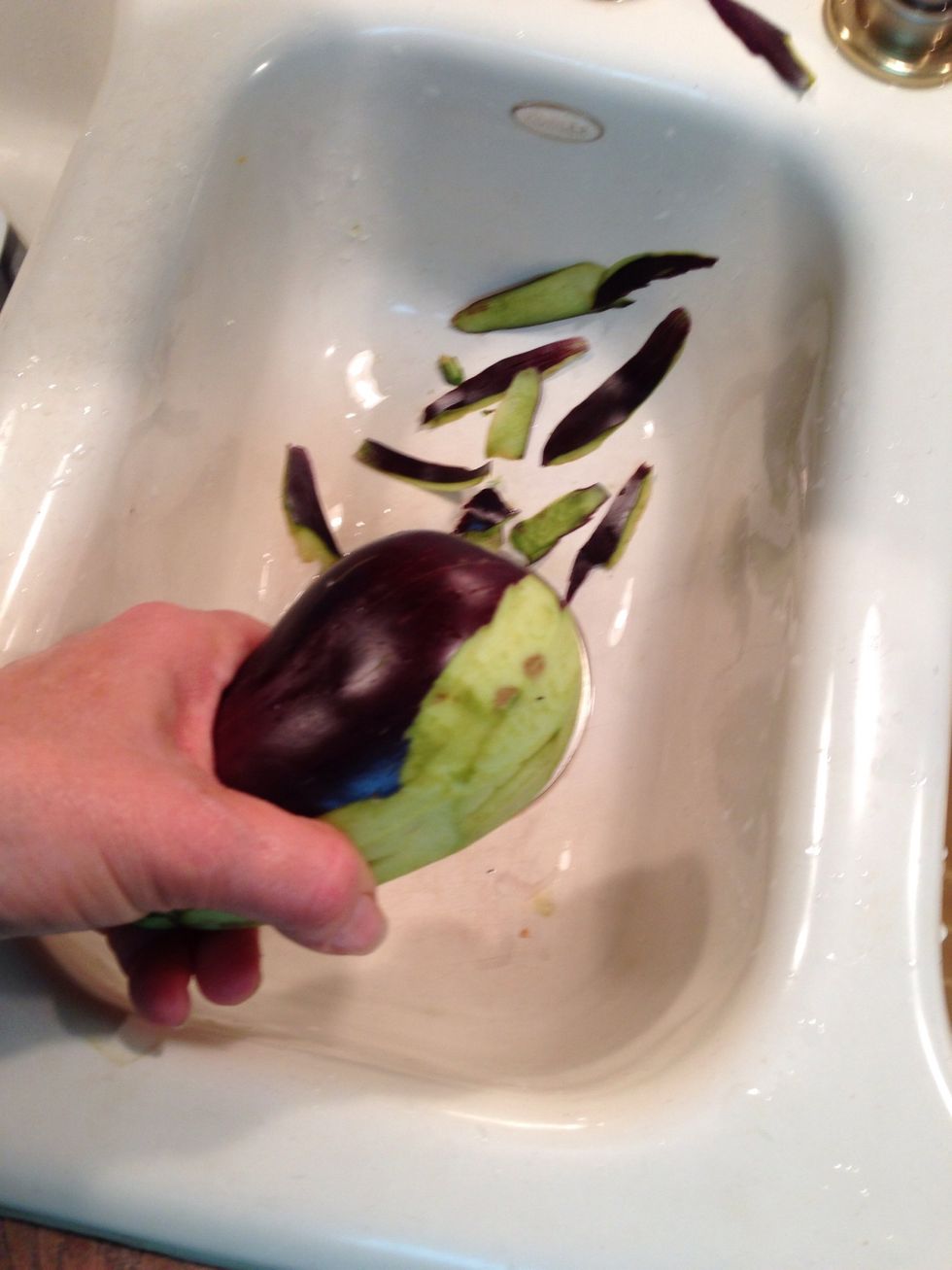 Eggplant can easily be peeled with a potato peeler. It will darken quickly so I like to have things ready to go.