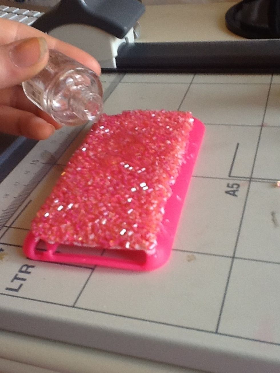 either spread on a transparent top coat nail varnish, or you can pour it on like i did. You can also use PVA glue, it would probably work better