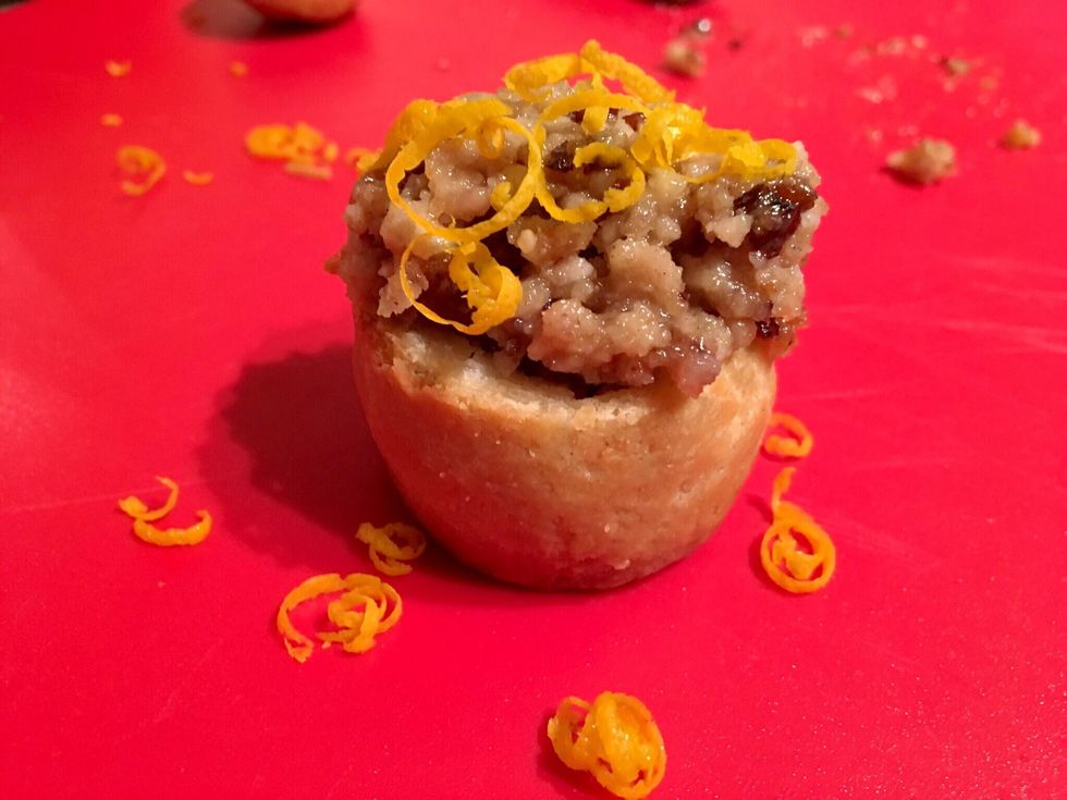 Either using a zester or a grater on your orange place a small amount on top of your pie