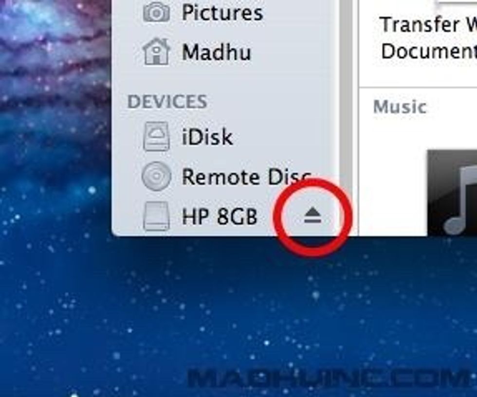 Eject symbol next to the name of the USB drive.