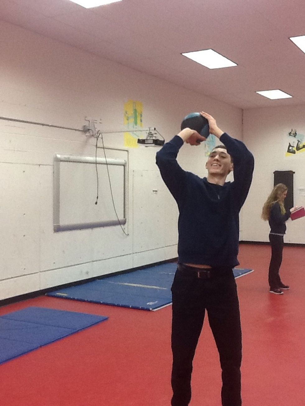 Elbow flexion; knee extension; right wrist extension, left wrist neutral ; biceps, triceps, deltoids are used feet are in neutral position. Biceps are going through conccentric contraction.