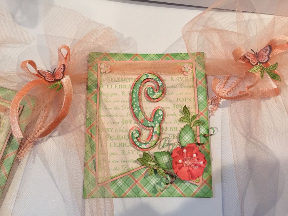 Embellish as desired. I made paper flowers, and added leaves and curlicues. Additionally, I added tulle bows, velvet bows and fussy cut butterfly's.