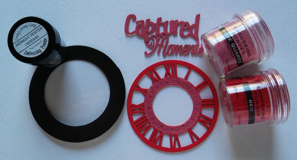 Emboss the Lens with Black and adhere a piece of acetate sheet behind it using glossy accents. Emboss the phrase & middle piece of the clock with pink. Emboss the numbers with red.