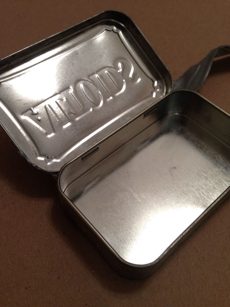 Empty & clean Altoids tin. Buffed to produce a reflection