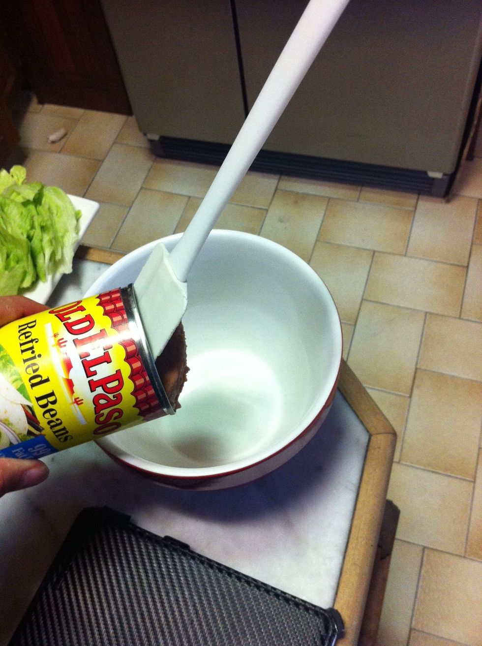 Empty refried beans into microwaveable dish
