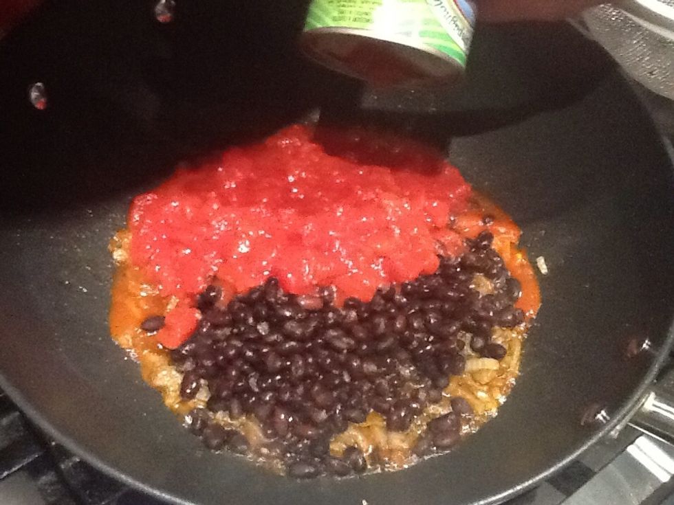 Empty the black beans into the onion mix, then add a tin of chopped tomatoes. Continue to mix.
