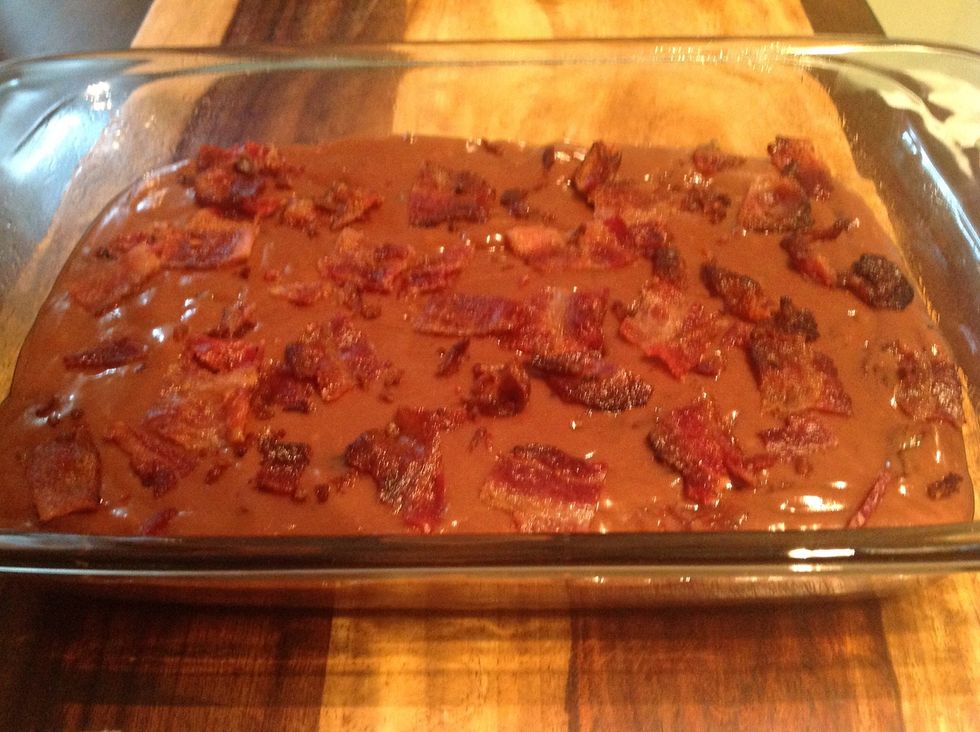 Empty the contents of the saucepan into the prepared pan and then scatter the reserved chopped bacon over the top.