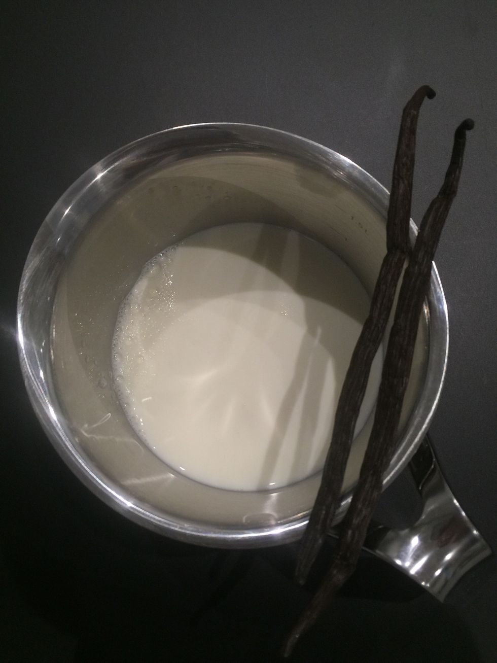 Empty the vanilla beans in the milk. Simmer 10 mins and let it infuse