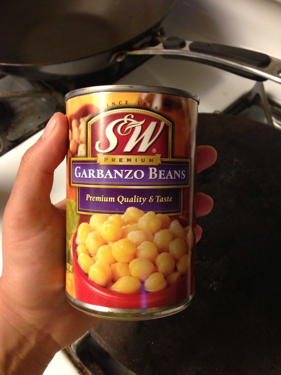 Empty three cans of garbanzo beans in a pot