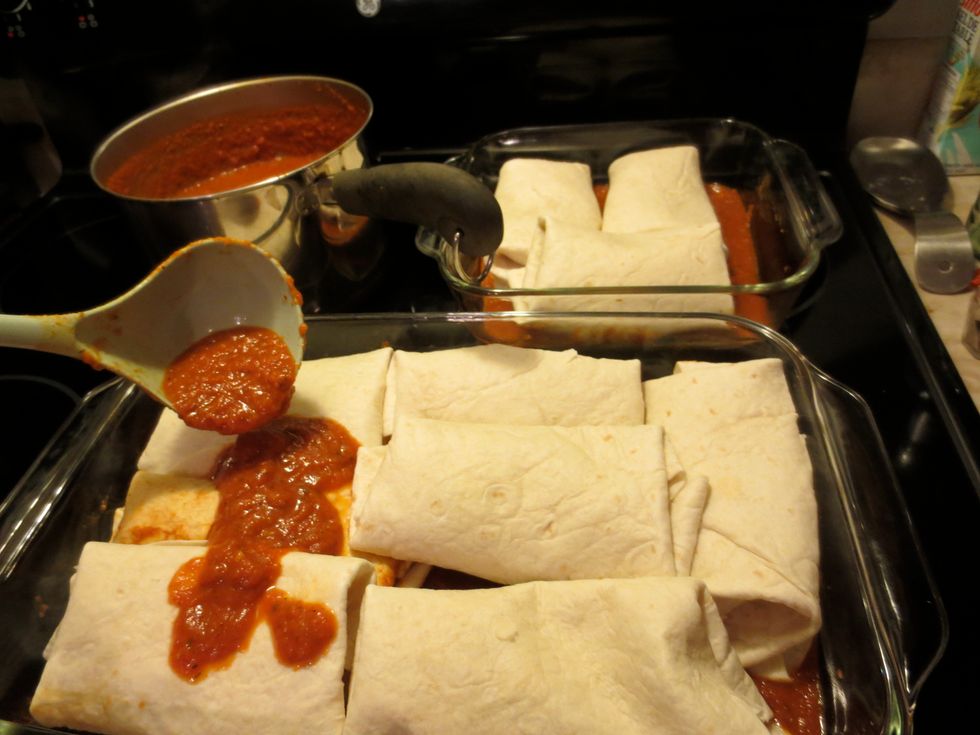 Enchilada sauce goes on, even coverage, not too heavy on the sauce, get exposed tortilla covered, it helps prevent sticking to the baking dish. No, I don't grease the dishes