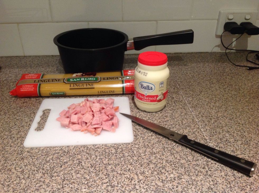 Equipment/Ingredients: Fettuccine, chopping board, thick cream, saucepan, knife and bacon.