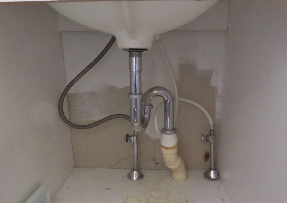 Establish where the supply lines and the drain line come through the wall. The size of the cabinet and the plumbing location is used to lay out the drawers.